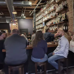 a group of people sitting at a bar