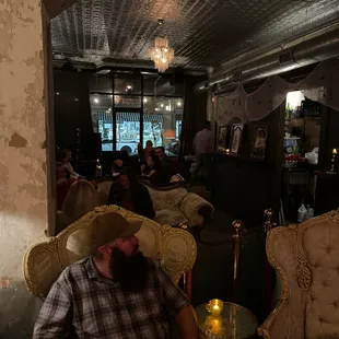 a man in a cowboy hat sitting in a chair