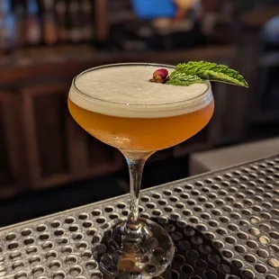 a cocktail sitting on a bar top