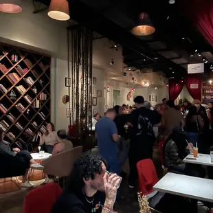 a crowd of people sitting at tables in a restaurant