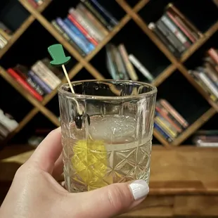 a person holding a glass of lemonade
