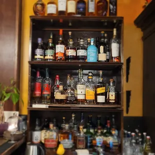 a shelf full of liquor bottles