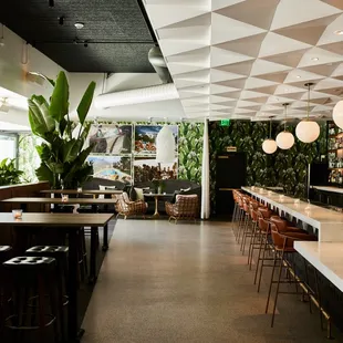 a restaurant with a long bar with a lot of tables and chairs