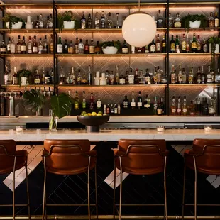 a bar with a lot of bottles on the shelves