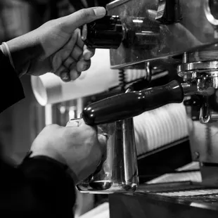a person using a coffee machine