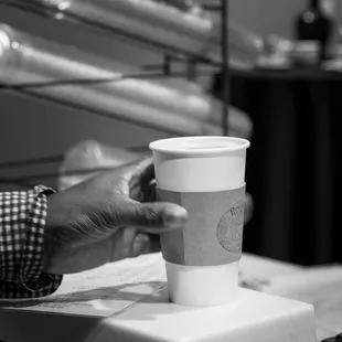 a person holding a coffee cup