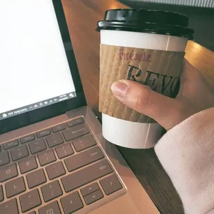 a person holding a cup of coffee