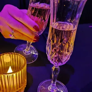 two glasses of wine and a candle