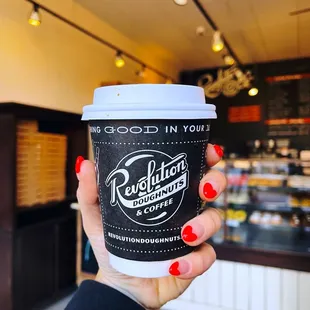 a hand holding a cup of coffee