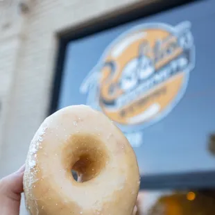 a hand holding a doughnut