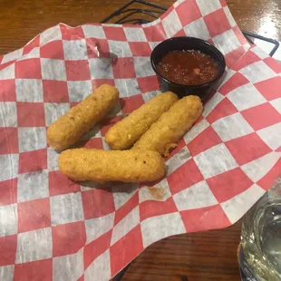 a basket of fried tater tots and a bowl of ketchup