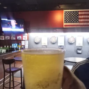 a person holding a glass of beer