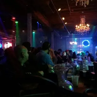 a group of people sitting at a bar