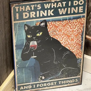a black cat holding a glass of wine