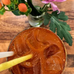 a person holding a drink with a straw