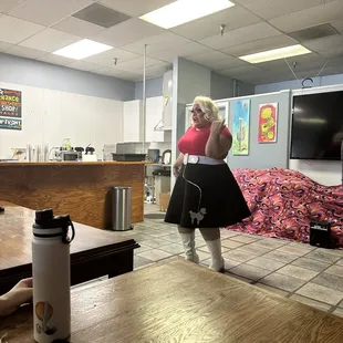 a woman in a pink top and black skirt