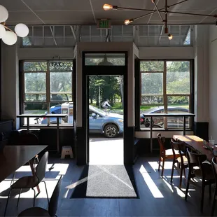 two people sitting at tables in a coffee shop