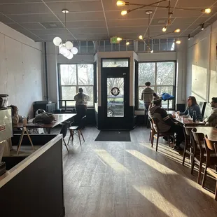 people sitting at tables in a coffee shop