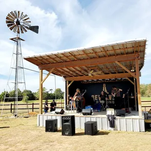 a stage with a windmill in the background
