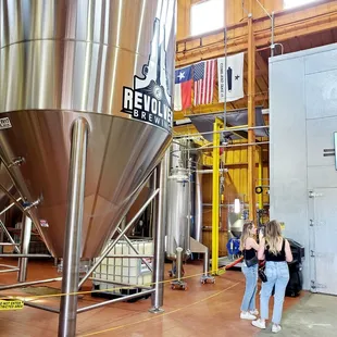 a woman and a man in a brewery