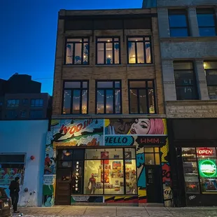 a building with a neon sign in front of it