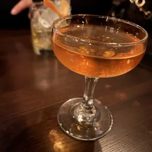 a glass of alcohol on a table