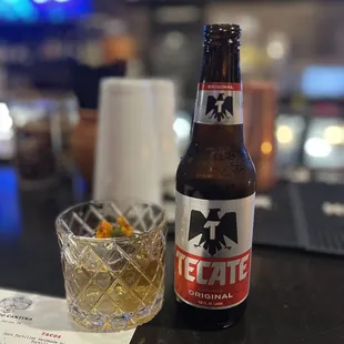 a glass of whiskey and a bottle