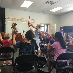 Learning about string instruments during one of our summer Exploring Instruments Camps