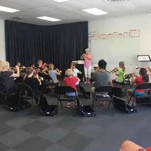 Trying out trumpet during an Exploring Instruments Camp