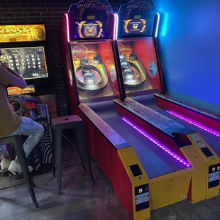 a woman playing a game of pinball