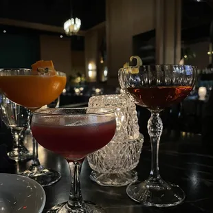 three cocktails on a bar