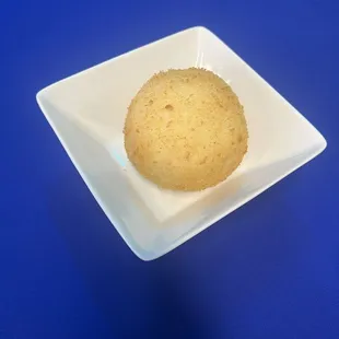 a square white plate with a pastry on it