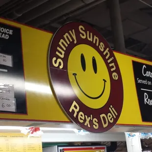 a yellow and red sign with a smiley face