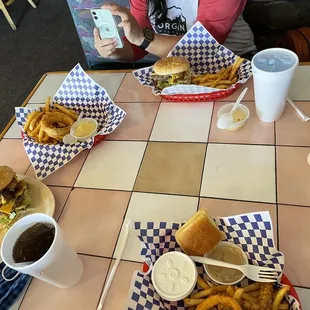 a woman taking a picture of her meal