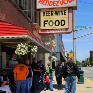 people standing outside of a restaurant