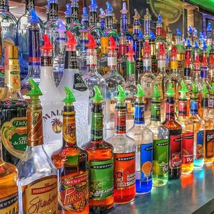 bottles of liquor lined up on a bar