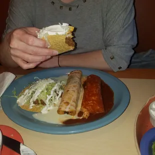 a woman eating a burrito and salsa