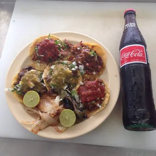 a plate of food and a bottle of coke