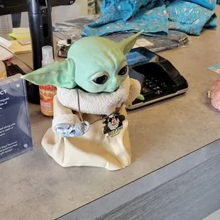 Cute Baby Yoda helping customers.