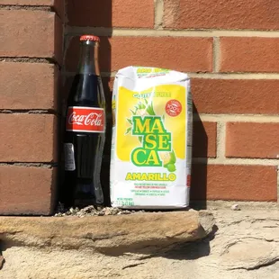 a bottle of soda and a bag of granola
