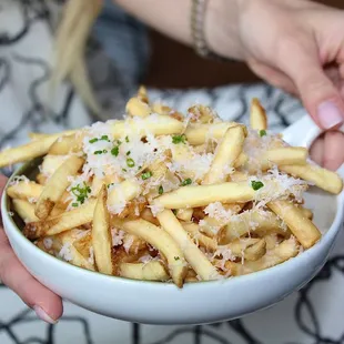 The Truffle Fries are made with grated parmesan and black truffle aioli.