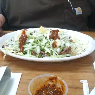 a man sitting at a table with a plate of food