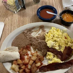 Huevos Rancheros plate with bacon and sausage.