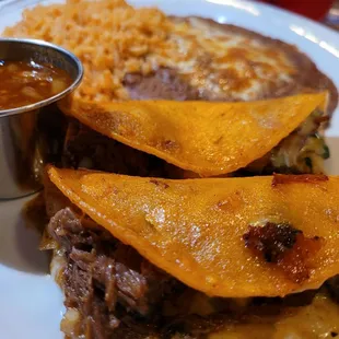 The Quesabirria tacos w/ beans &amp; rice.