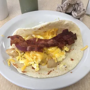 Potato egg bacon and cheese taco. Love the breakfast tacos here!