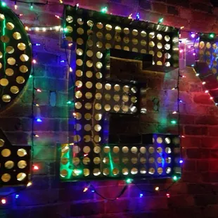 a neon sign on a brick wall