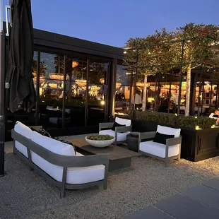 As the sun sets, the indoor chandeliers shine through the atrium.