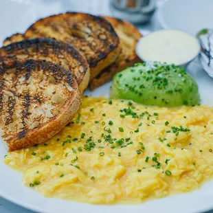 a plate of scrambled eggs and toast