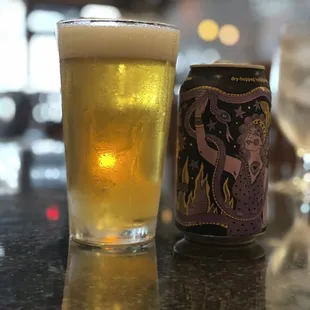 a glass of beer and a can of beer