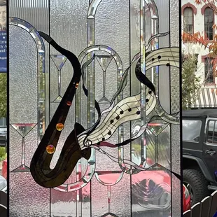 a stained glass picture of a saxophone player